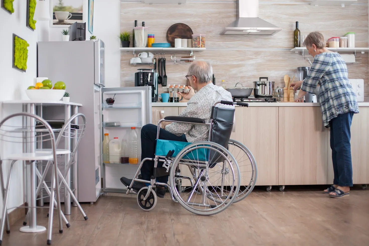 Man with disability helping his wife with daily household tasks